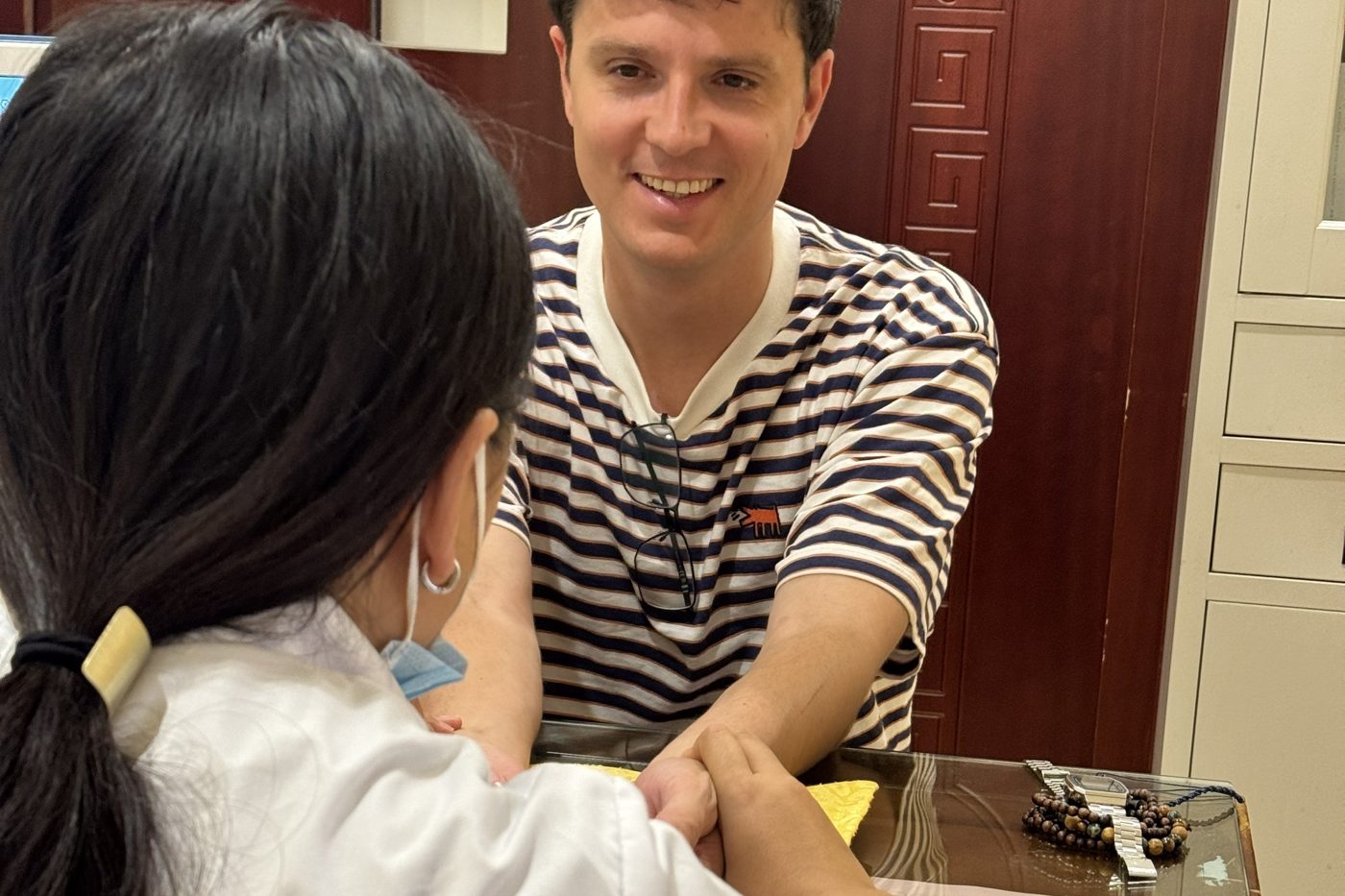 Pulse diagnosis at Dr. Yang's clinic in Kunming