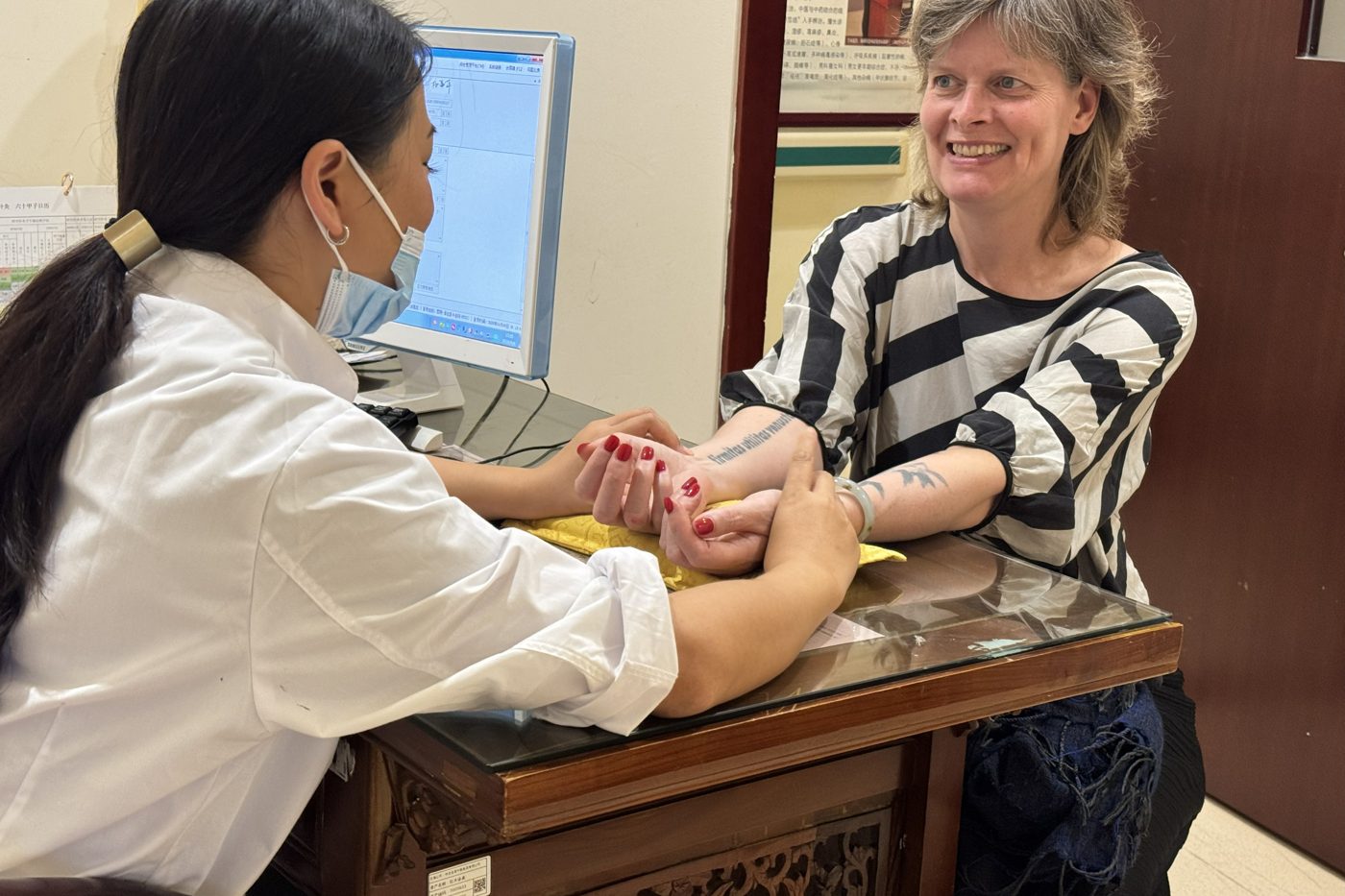 Pulse diagnosis at Dr. Yang's clinic in Kunming